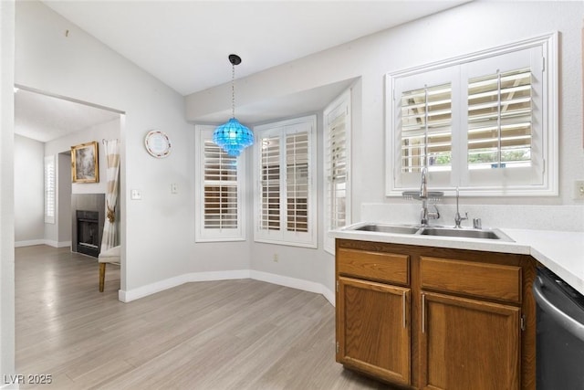 3157 Capetown Way, Las Vegas, NV 89128 - kitchen with stainless steel dishwasher, light wood finished floors, a sink, decorative light fixtures, and lofted ceiling