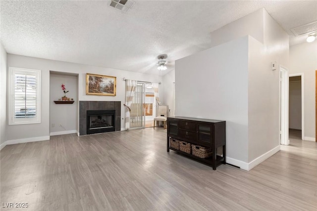 3157 Capetown Way, Las Vegas, NV 89128 - living area with a textured ceiling, wood finished floors, a ceiling fan, baseboards, and a fireplace
