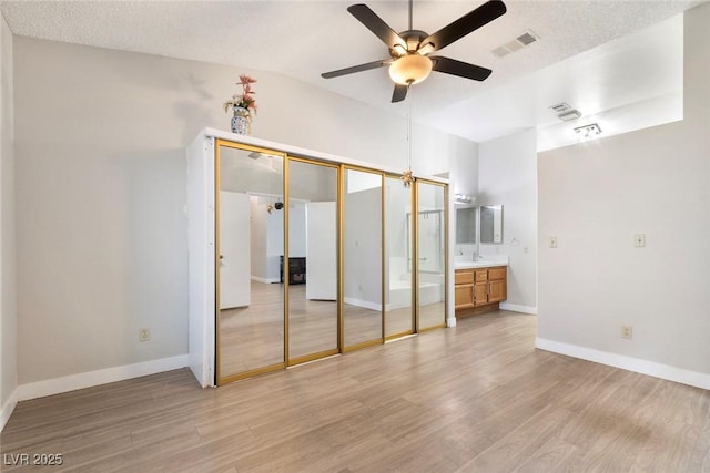 3157 Capetown Way, Las Vegas, NV 89128 - unfurnished bedroom with light wood-style flooring, a sink, baseboards, and a ceiling fan