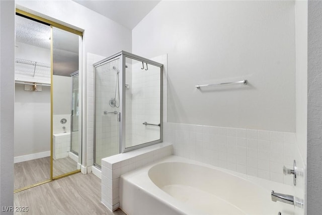 3157 Capetown Way, Las Vegas, NV 89128 - full bath with a garden tub, a shower stall, wood finished floors, and a walk in closet