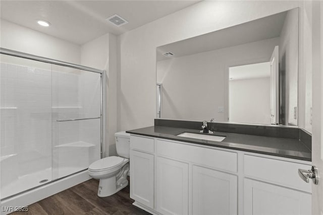 6197 Blood Lily Ave, Las Vegas, NV 89122 - full bathroom featuring toilet, wood finished floors, a shower stall, and vanity
