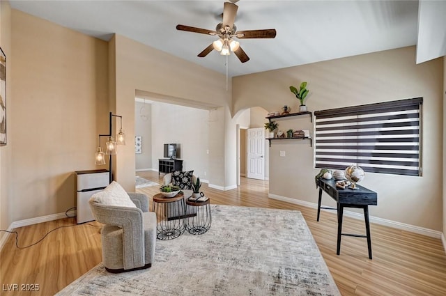 8223 Saddleback Ledge Ave, Las Vegas, NV 89147 - living area with ceiling fan, arched walkways, wood finished floors, and baseboards