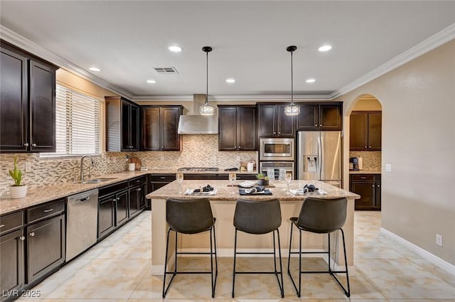 8223 Saddleback Ledge Ave, Las Vegas, NV 89147 - kitchen featuring wall chimney exhaust hood, appliances with stainless steel finishes, a sink, arched walkways, and crown molding