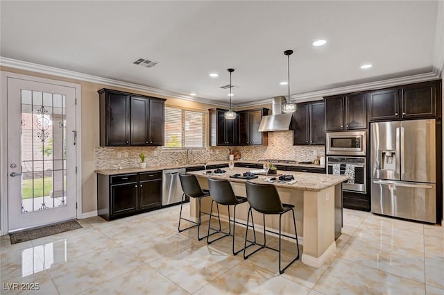 8223 Saddleback Ledge Ave, Las Vegas, NV 89147 - kitchen with stainless steel appliances, ornamental molding, wall chimney exhaust hood, tasteful backsplash, and a kitchen breakfast bar