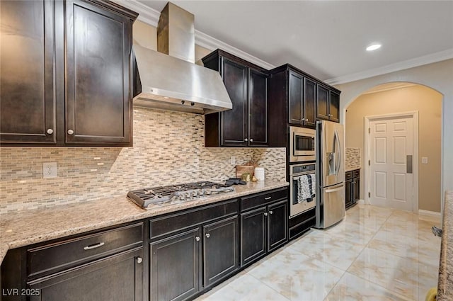 8223 Saddleback Ledge Ave, Las Vegas, NV 89147 - kitchen featuring wall chimney range hood, appliances with stainless steel finishes, crown molding, arched walkways, and light marble finish floors