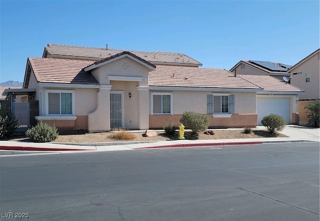 4718 Victoria Garden Ave, North Las Vegas, NV 89031 - ranch-style house featuring a tile roof, an attached garage, stucco siding, and driveway