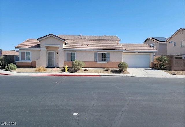 4718 Victoria Garden Ave, North Las Vegas, NV 89031 - ranch-style house featuring a garage, a tiled roof, concrete driveway, and stucco siding