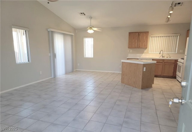 4718 Victoria Garden Ave, North Las Vegas, NV 89031 - kitchen featuring a center island, light countertops, ceiling fan, a sink, and open floor plan