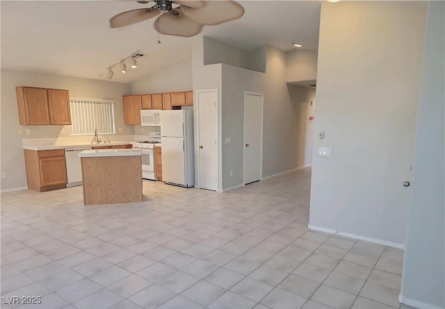 4718 Victoria Garden Ave, North Las Vegas, NV 89031 - kitchen with white appliances, a sink, ceiling fan, light countertops, and a center island