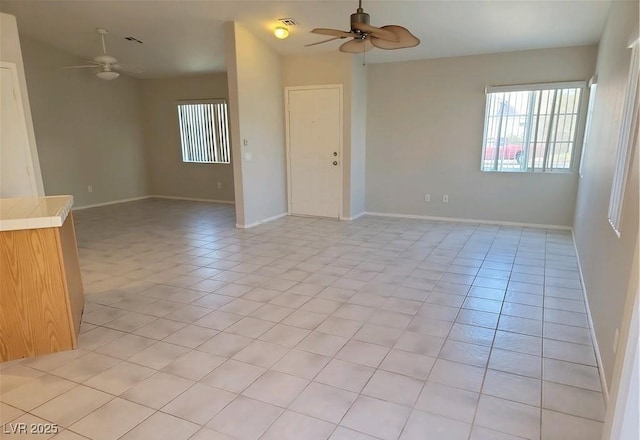 4718 Victoria Garden Ave, North Las Vegas, NV 89031 - empty room featuring a ceiling fan, baseboards, and light tile patterned floors