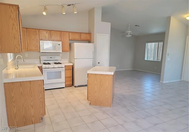 4718 Victoria Garden Ave, North Las Vegas, NV 89031 - kitchen with white appliances, a sink, ceiling fan, a kitchen island, and vaulted ceiling