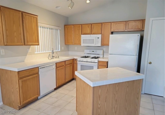 4718 Victoria Garden Ave, North Las Vegas, NV 89031 - kitchen featuring white appliances, a sink, vaulted ceiling, light tile patterned flooring, and a kitchen island