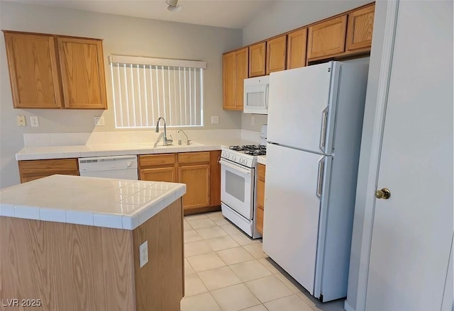 4718 Victoria Garden Ave, North Las Vegas, NV 89031 - kitchen with white appliances, tile countertops, light tile patterned flooring, a sink, and brown cabinets