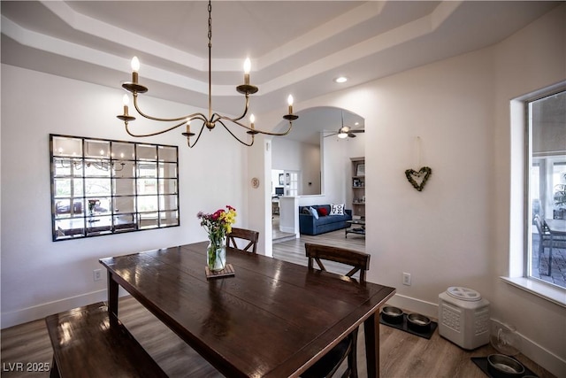 3236 Cliff Sieler Ct, Las Vegas, NV 89117 - dining room featuring a raised ceiling, a chandelier, wood finished floors, and baseboards