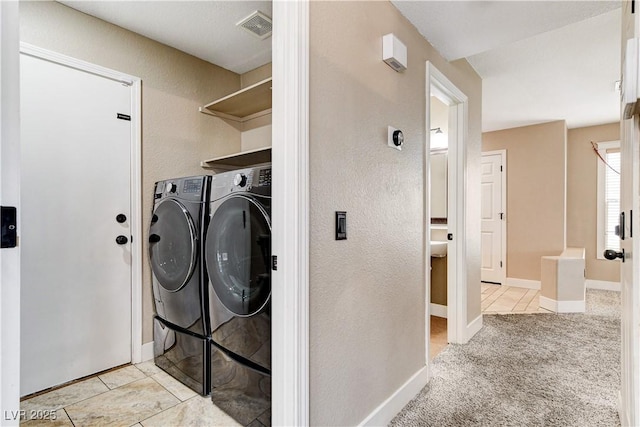 3717 Shanagolden St, Las Vegas, NV 89129 - laundry room with washing machine and clothes dryer, light tile patterned flooring, light carpet, and baseboards