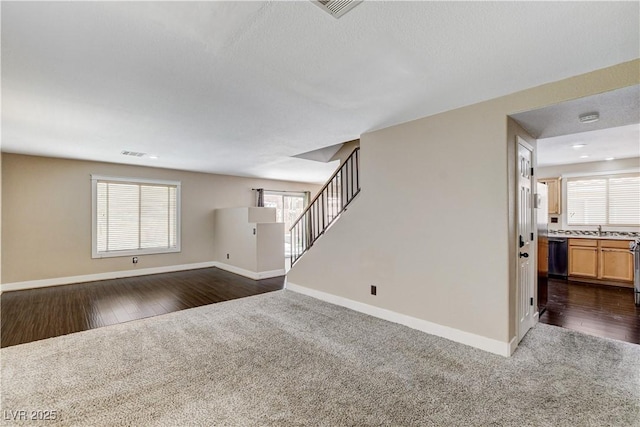 3717 Shanagolden St, Las Vegas, NV 89129 - unfurnished living room with baseboards, dark carpet, and a sink