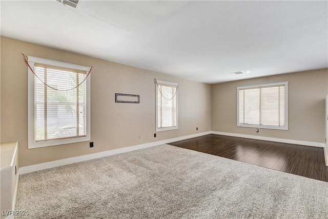3717 Shanagolden St, Las Vegas, NV 89129 - empty room with baseboards, plenty of natural light, and dark colored carpet
