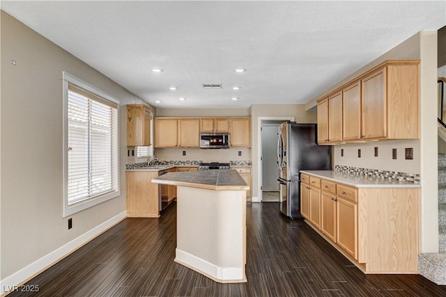 3717 Shanagolden St, Las Vegas, NV 89129 - kitchen featuring appliances with stainless steel finishes, light brown cabinets, a center island, baseboards, and dark wood finished floors