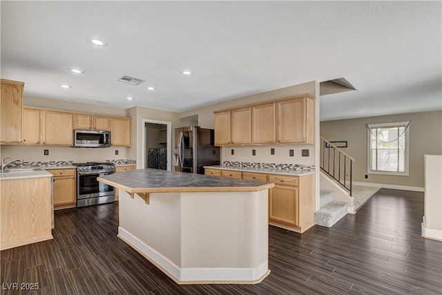 3717 Shanagolden St, Las Vegas, NV 89129 - kitchen featuring appliances with stainless steel finishes, light brown cabinets, baseboards, a kitchen island, and recessed lighting