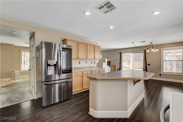 3717 Shanagolden St, Las Vegas, NV 89129 - kitchen featuring stainless steel refrigerator with ice dispenser, light brown cabinetry, tile counters, baseboards, and plenty of natural light