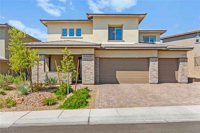 767 Tallgrass St, Las Vegas, NV 89138 - prairie-style house featuring an attached garage, stucco siding, decorative driveway, and stone siding