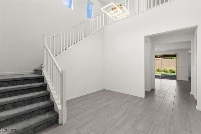 767 Tallgrass St, Las Vegas, NV 89138 - staircase featuring a high ceiling, baseboards, and a chandelier