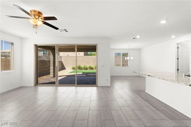 767 Tallgrass St, Las Vegas, NV 89138 - spare room featuring a ceiling fan, recessed lighting, baseboards, wood finished floors, and a chandelier