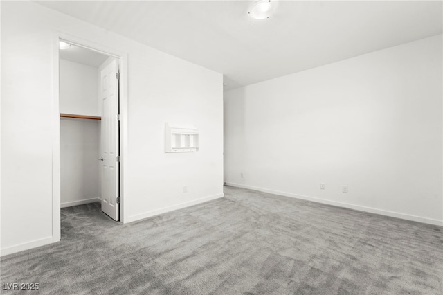 767 Tallgrass St, Las Vegas, NV 89138 - unfurnished bedroom with carpet flooring, a walk in closet, and baseboards