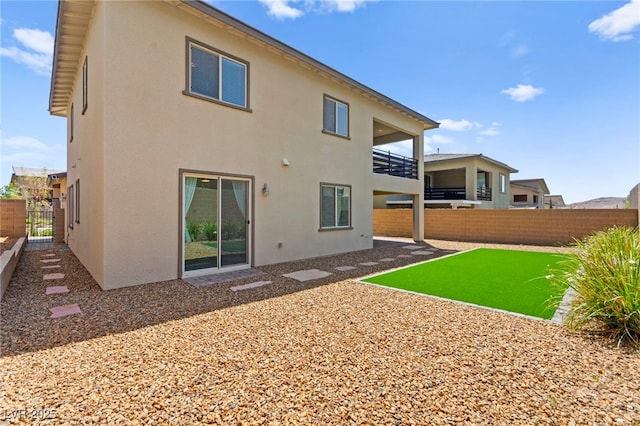 767 Tallgrass St, Las Vegas, NV 89138 - rear view of house featuring stucco siding, a fenced backyard, and a balcony