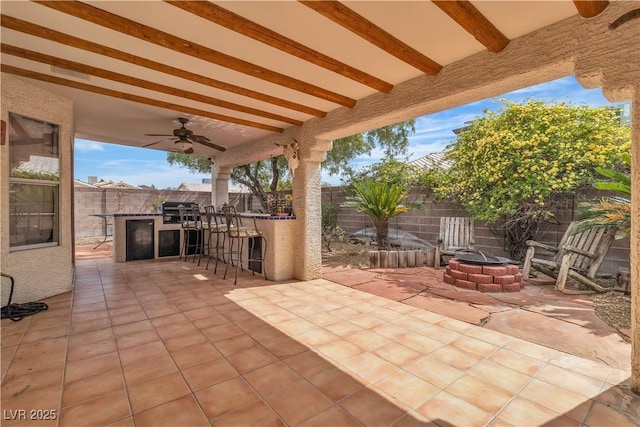 6405 Break Point Ave, Las Vegas, NV 89130 - fenced backyard with a fire pit, a ceiling fan, and a patio