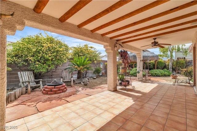 6405 Break Point Ave, Las Vegas, NV 89130 - fenced backyard featuring a ceiling fan, an outdoor fire pit, and a patio area