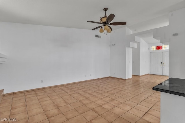 6405 Break Point Ave, Las Vegas, NV 89130 - unfurnished living room featuring ceiling fan, light tile patterned flooring, and lofted ceiling