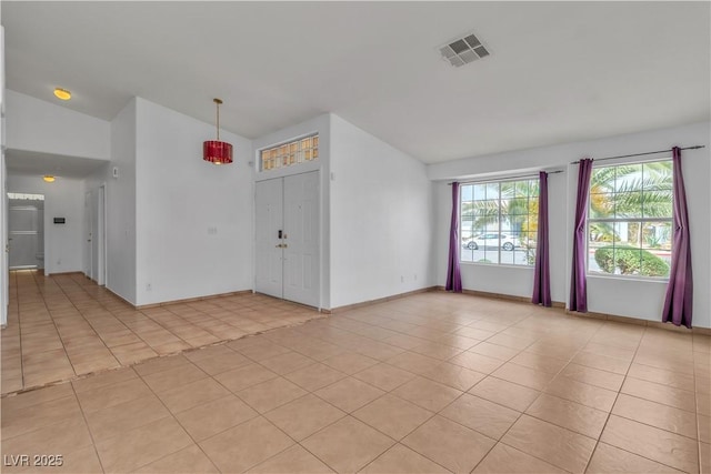 6405 Break Point Ave, Las Vegas, NV 89130 - spare room with vaulted ceiling, light tile patterned floors, and baseboards