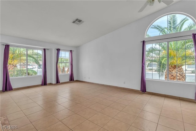 6405 Break Point Ave, Las Vegas, NV 89130 - spare room featuring lofted ceiling, light tile patterned floors, a ceiling fan, and baseboards