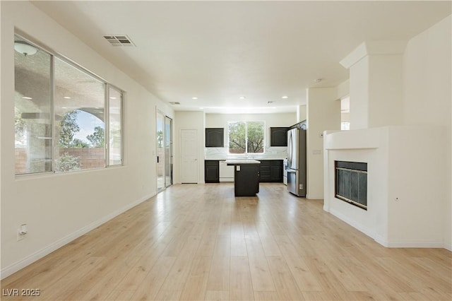 8224 Cassis Ct, Las Vegas, NV 89117 - unfurnished living room with light wood finished floors, baseboards, a glass covered fireplace, and recessed lighting