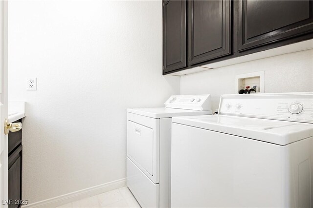 8224 Cassis Ct, Las Vegas, NV 89117 - laundry area with washing machine and clothes dryer, baseboards, and cabinet space