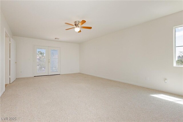 8224 Cassis Ct, Las Vegas, NV 89117 - unfurnished room with light carpet, a ceiling fan, and french doors