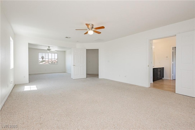 8224 Cassis Ct, Las Vegas, NV 89117 - unfurnished room featuring light carpet, a ceiling fan, and baseboards