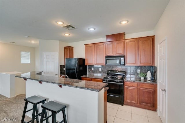 1370 Crystal Hill Ln Unit 3, Henderson, NV 89012 - kitchen featuring black appliances, a breakfast bar area, brown cabinets, tasteful backsplash, and recessed lighting