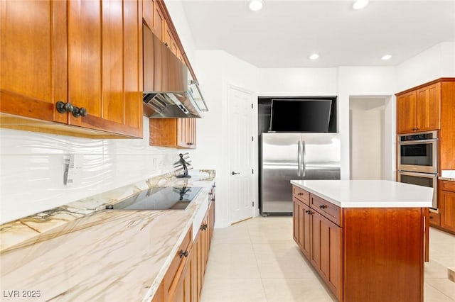 20 Kittansett Loop, Henderson, NV 89052 - kitchen with appliances with stainless steel finishes, under cabinet range hood, brown cabinetry, a kitchen island, and recessed lighting