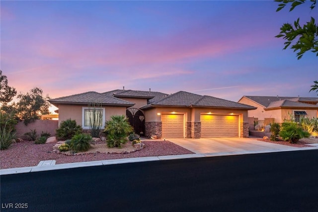 20 Kittansett Loop, Henderson, NV 89052 - view of front of property with an attached garage, stone siding, stucco siding, and driveway