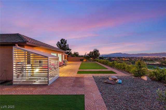 20 Kittansett Loop, Henderson, NV 89052 - yard at dusk featuring a game area and a mountain view