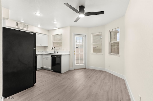 7566 Glowing Ember Ct Unit 101, Las Vegas, NV 89130 - kitchen with black appliances, baseboards, light wood-type flooring, light countertops, and a ceiling fan