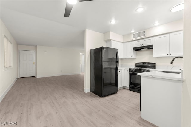 7566 Glowing Ember Ct Unit 101, Las Vegas, NV 89130 - kitchen featuring black appliances, under cabinet range hood, a sink, light wood-style flooring, and a ceiling fan