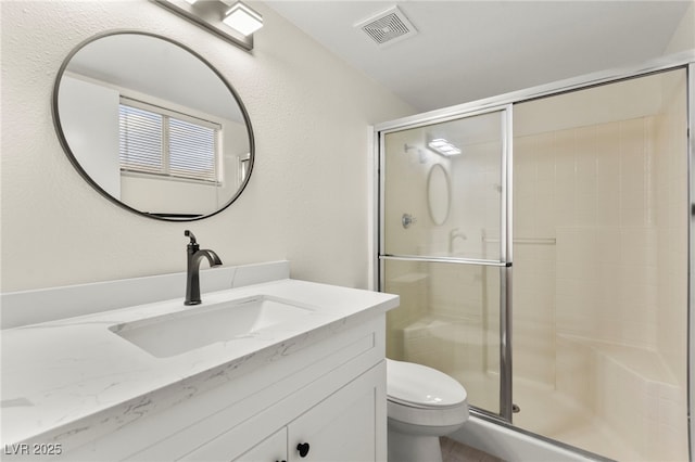 7566 Glowing Ember Ct Unit 101, Las Vegas, NV 89130 - full bathroom with vanity, a stall shower, and toilet