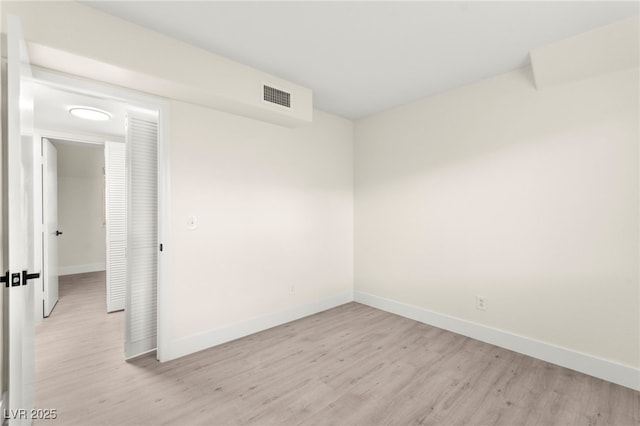 7566 Glowing Ember Ct Unit 101, Las Vegas, NV 89130 - unfurnished room with light wood-style floors and baseboards