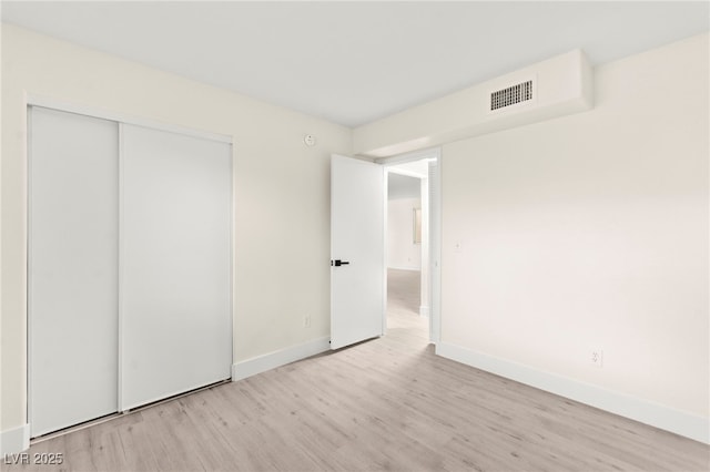 7566 Glowing Ember Ct Unit 101, Las Vegas, NV 89130 - unfurnished bedroom with wood finished floors, a closet, and baseboards