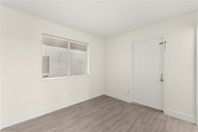 7566 Glowing Ember Ct Unit 101, Las Vegas, NV 89130 - unfurnished room featuring light wood-style flooring and baseboards