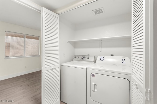 7566 Glowing Ember Ct Unit 101, Las Vegas, NV 89130 - washroom featuring washer and clothes dryer, light wood-style floors, and baseboards