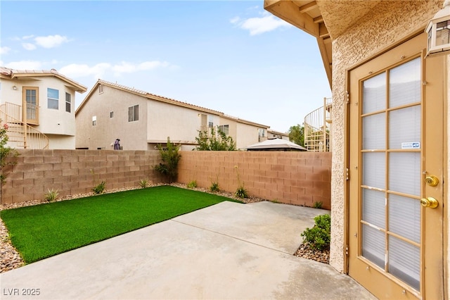 7566 Glowing Ember Ct Unit 101, Las Vegas, NV 89130 - fenced backyard featuring a patio area and a residential view